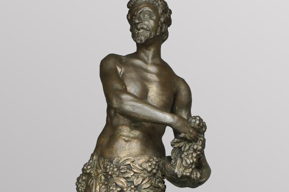 A firedog depicting Bacchus