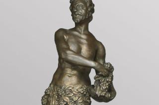 A firedog depicting Bacchus